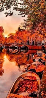 Vibrant orange autumn canal with boats and reflections.