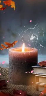 Lit candle with autumn leaves on a rustic background.