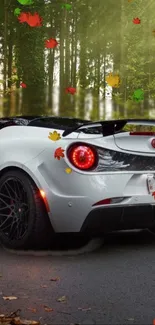 White sports car with autumn leaves and forest backdrop.