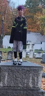 Autumn cemetery with fallen leaves and gravestones backdrop.