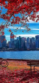 Mobile wallpaper of red autumn leaves framing a city skyline.