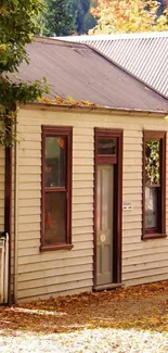 Charming autumn cottage surrounded by vibrant fall foliage.