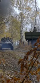 Military vehicles in autumn forest path with fall leaves.