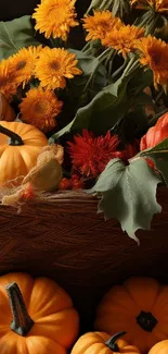 Colorful autumn scene with pumpkins and flowers in a basket.