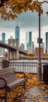 NYC skyline with Brooklyn Bridge and autumn leaves.
