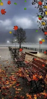 Serene lakeside scene with autumn leaves and benches along a foggy walkway.