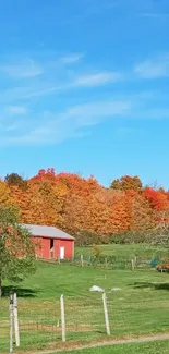 Countryside in autumn with colorful foliage and a blue sky.