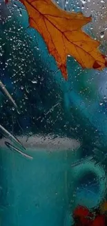 Autumn leaf on rain-soaked window with blue background.