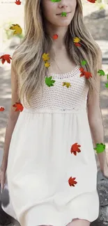 A girl in a white dress surrounded by colorful autumn leaves.