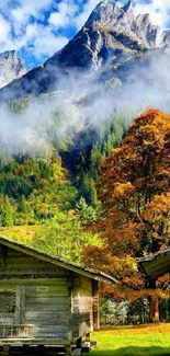 Rustic autumn mountain scene with cabins and vibrant trees.