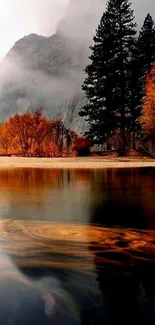 Autumn mountain lake with misty peaks and trees in vibrant colors.