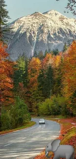 Scenic autumn road with mountains and colorful foliage in vibrant view.