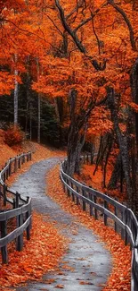 Serene autumn pathway with orange leaves and wooden fence.