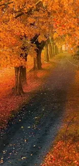 Autumn pathway with orange leaves and serene tree-lined view.