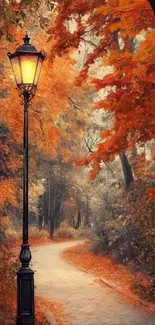 Autumn pathway with orange leaves and a classic lamp post.