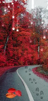 Curving path through vibrant red autumn forest with scattered leaves.