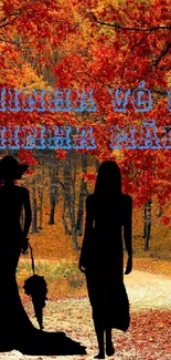 Silhouettes of women against vibrant autumn leaves.