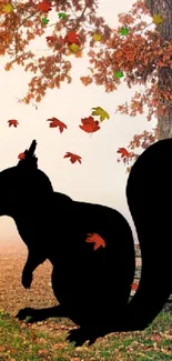 Silhouette of a squirrel under a vibrant tree in autumn landscape.