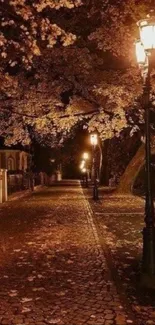 Mobile wallpaper of an autumn street with glowing lamps and a cobblestone path.