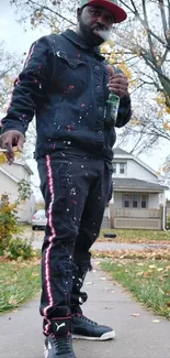 Man in street style fashion on an autumn street with colorful leaves.