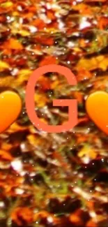 Autumnal orange mobile wallpaper with heart symbols and the letter G.