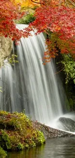 Autumn waterfall with red leaves in a serene forest scene.