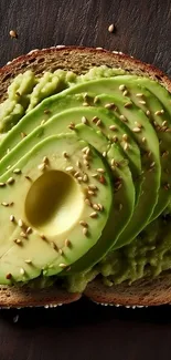 Avocado toast topped with sesame seeds on a wooden surface.