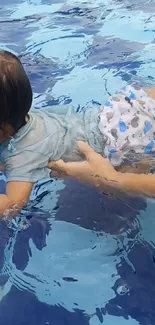 Baby swimming in a blue pool with vibrant colors.