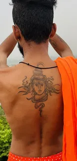 Back tattoo design with spiritual motifs and orange cloth.