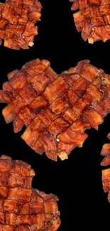 Heart-shaped bacon pattern on black background.