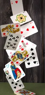 A stack of playing cards artistically balanced against a wooden backdrop.