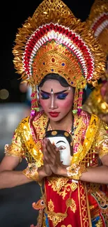 Balinese dancer in colorful traditional attire and headdress.