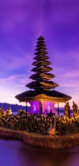 Bali temple at dusk with purple skies and reflections.