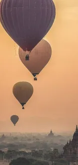 Hot air balloons soaring over ancient temples at sunrise.