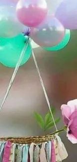 Pastel balloons over a flower basket on mobile wallpaper.