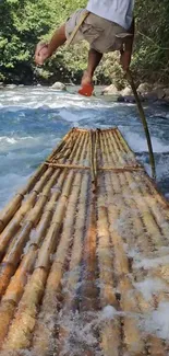 Bamboo raft on a flowing river with lush greenery background.