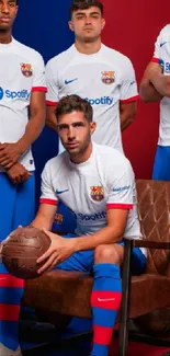 Barcelona football team in white and blue uniforms posing for a group photo.