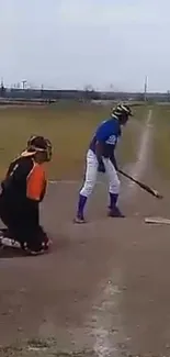 Batter and catcher on a baseball field preparing for the pitch.