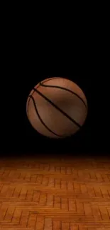 Basketball on a wooden court with a dark background.