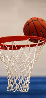 Basketball poised on rim in vibrant sports wallpaper.