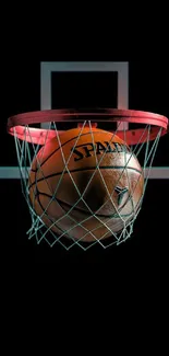 Basketball passing through a hoop on a dark background.