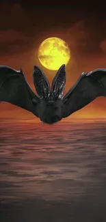 Bat silhouette with full moon over ocean at sunset.