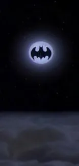 Batman signal shines in the night sky over clouds.