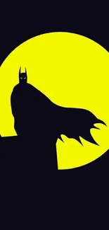 Silhouette of Batman against a yellow moon background.