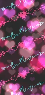 Black wallpaper with pink hearts and blue arrows repeating pattern.