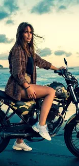 Woman on a motorcycle at the beach during sunset with scenic ocean view.