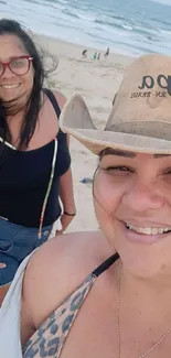 Two smiling women enjoying a beach day.