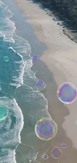 Aerial view of beach with rainbow bubbles and ocean waves.