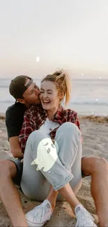 Romantic couple on beach with sunset in background.