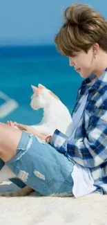 Person and cat relaxing on a sunny beach.